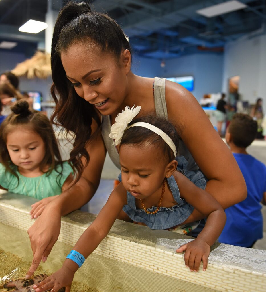 Mom and Daughter in the touch tank at SeaQuest