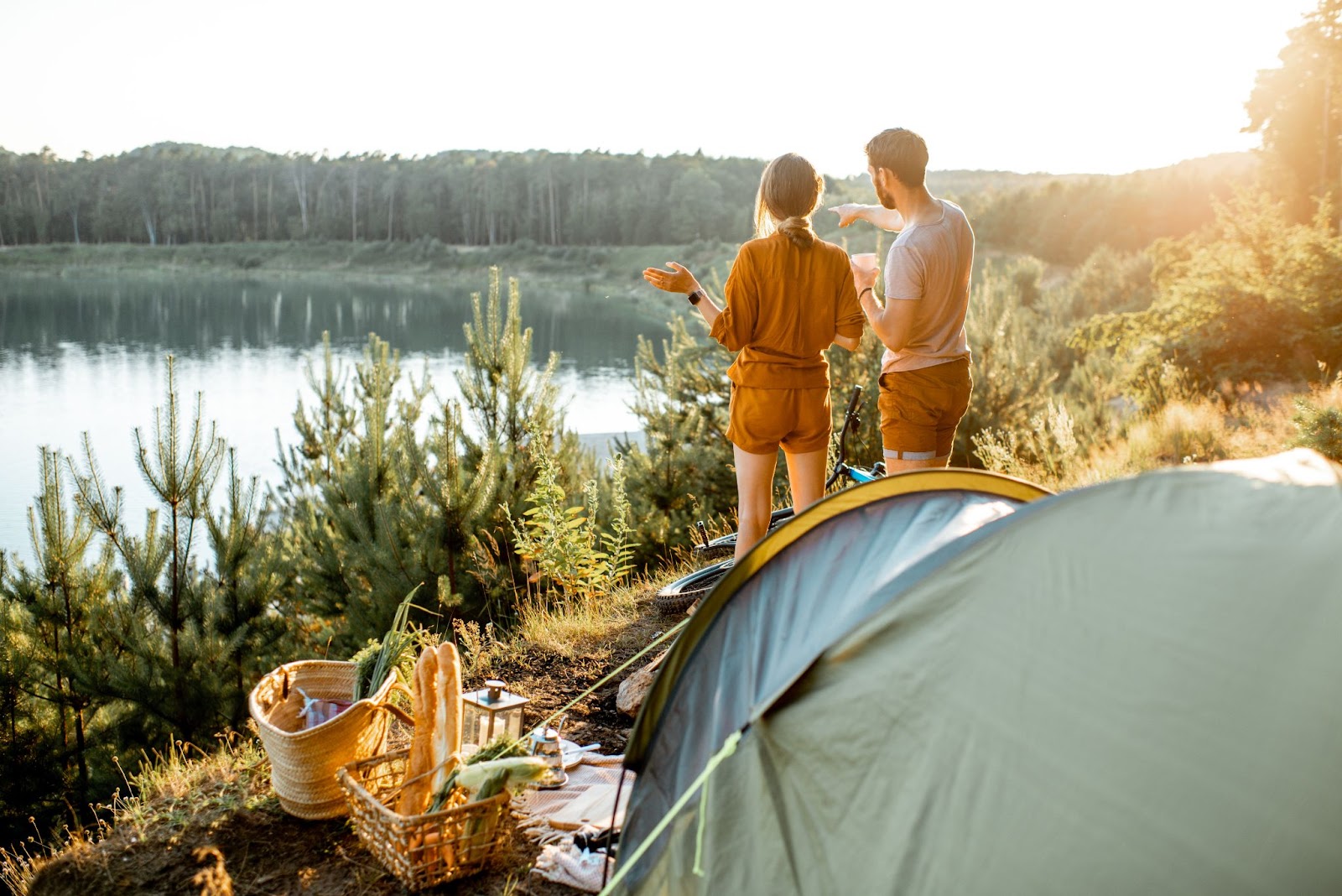 Couple camping and picnic near the lake together.