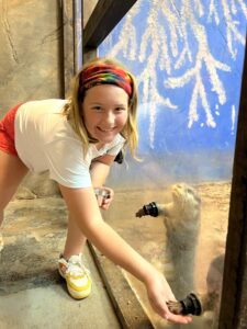 Girl feeds otters at SeaQuest Aquarium